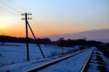 Railroad track during sunny winter morningの写真素材