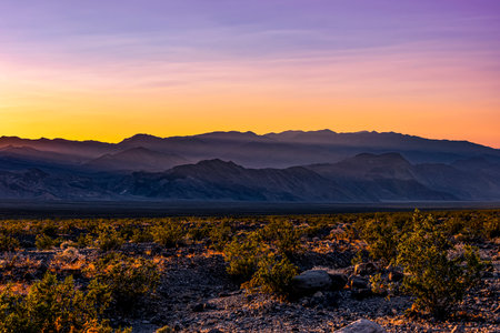 Beautiful scenery in Death Valley National Park. Orange and purple sky created by the setting sunの写真素材