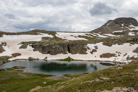 Beautiful mountain view with a clear, blue lake. Beautiful blue sky with clouds. Summer photo, but glaciers still have some snow left.の写真素材