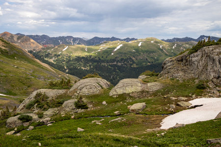 Amazing scenery. Mountain and valleys provide unbeatable natural scene. Summer colors with some snow still peaking out here and there.の写真素材
