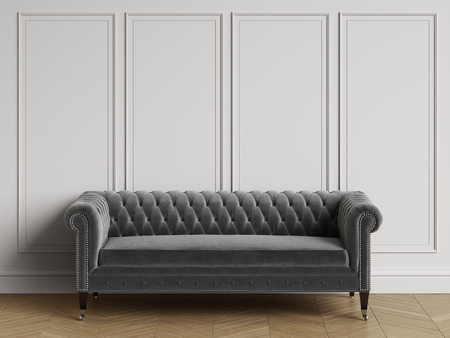 Classic tufted sofa  in classic interior with copy space.White walls with mouldings. Floor parquet...