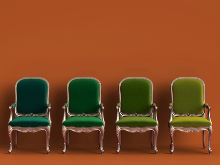 Classic chairs in different green colors on orange background with copy space.Digital...