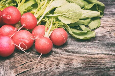 Fresh radishes on wooden tableの写真素材