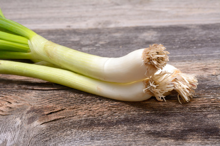 Green onion on wooden tableの写真素材