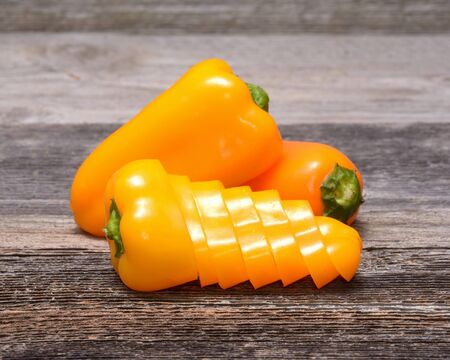 Fresh colorful capsicum on a wooden backgroundの写真素材