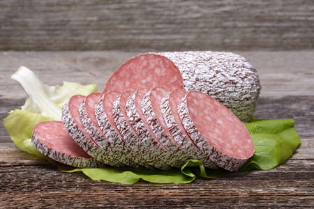 Salami sausage on wooden tableの写真素材