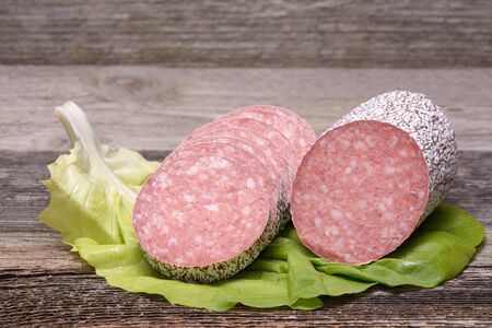 Salami sausage on wooden tableの写真素材