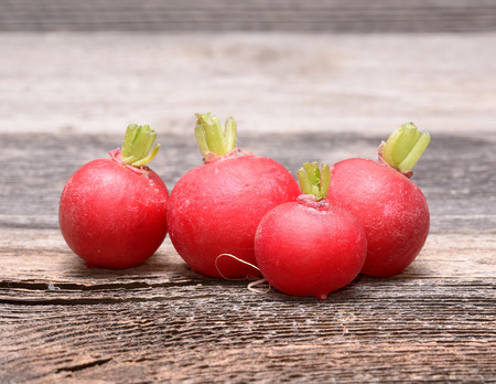 Fresh radishes on wooden tableの写真素材