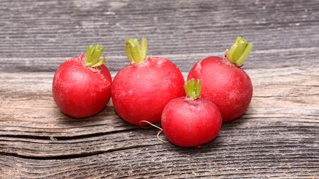 Fresh radishes on wooden tableの写真素材