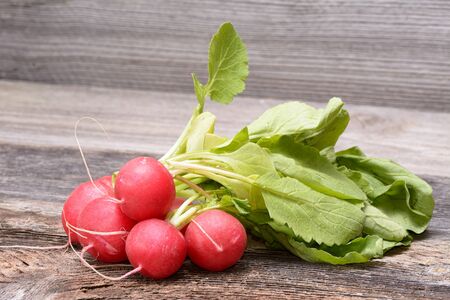Fresh radishes on wooden tableの写真素材
