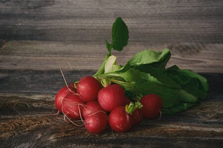 Fresh radishes on wooden tableの写真素材