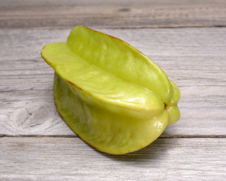Star fruit - carambola isolated on wooden tableの写真素材