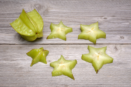 Star fruit - carambola isolated on wooden tableの写真素材