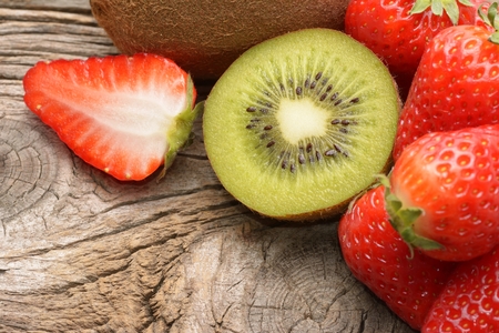 Kiwi and strawberry on wooden backgroundの写真素材