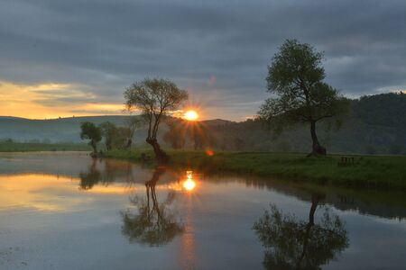 sunset over a small lakeの写真素材