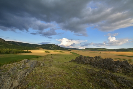 fields in spring and cloudy skyの写真素材