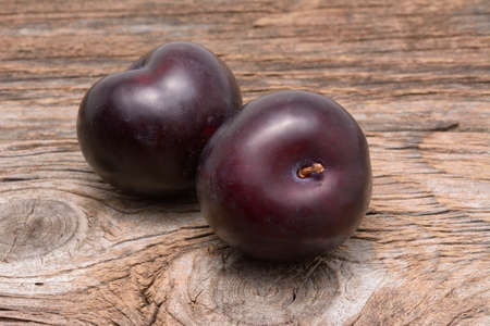 Sweet plums on wooden backgroundの写真素材