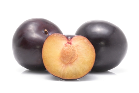 black plums isolated on white backgroundの写真素材