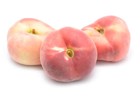 chinese flat peaches isolated on white backgroundの写真素材