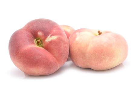 chinese flat peaches isolated on white backgroundの写真素材