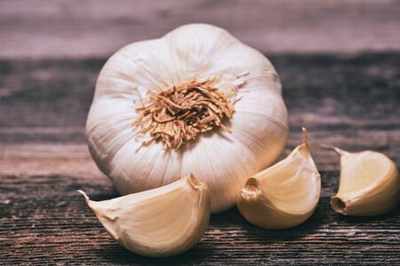 Garlic cloves on wooden vintage background