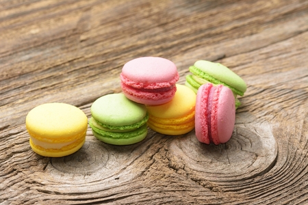 Different kinds of macaroons on wooden backgroundの写真素材