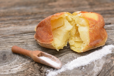 Baked potatoes on wooden tableの写真素材