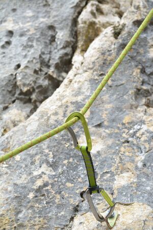 Carbine and hook with rope in stone