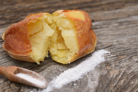 Baked potates on wooden boardの写真素材