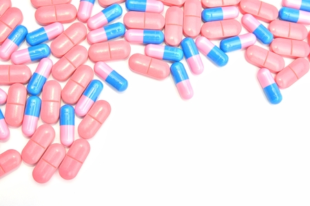 pink pills over white backgroundの写真素材