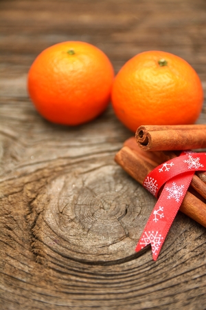 Christmas composition with fresh mandarin oranges, cinnamon and walnut on wooden backgroundの写真素材