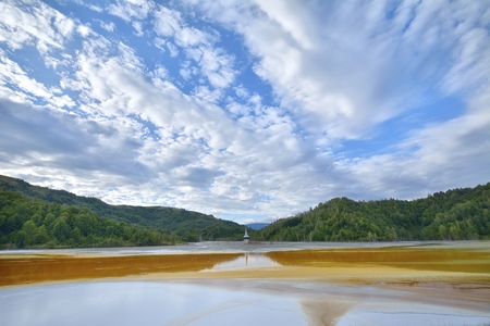 Beautiful landscape with polluted lake by copper miningの写真素材