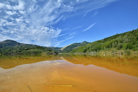 Beautiful landscape with polluted lake by copper miningの写真素材