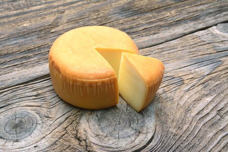Cheese wheel on wooden tableの写真素材