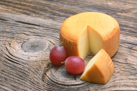 Cheese wheel on wooden tableの写真素材