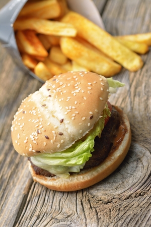 hamburger and french fries on wooden backgroundの写真素材