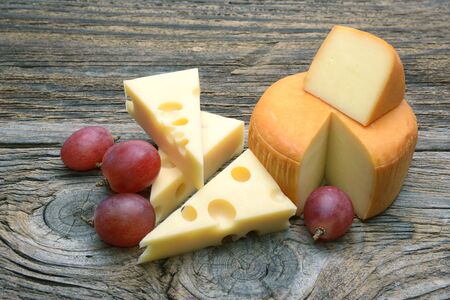 Emmental cheese on the cutting boardの写真素材