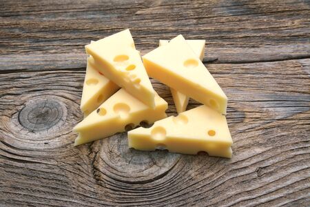 Emmental cheese on the cutting boardの写真素材