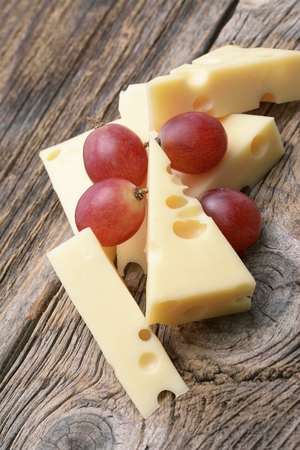 Emmental cheese on the cutting boardの写真素材