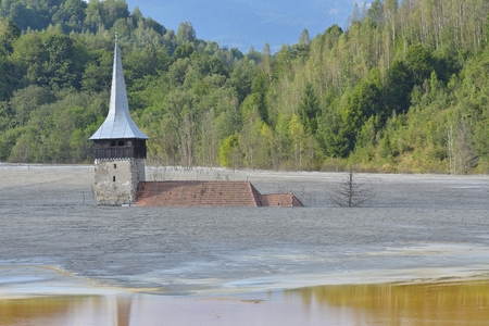 Flooded and abandoned church in the middle of a contaminated lakeの写真素材