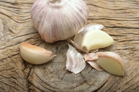 Garlic cloves on wooden vintage background.の写真素材