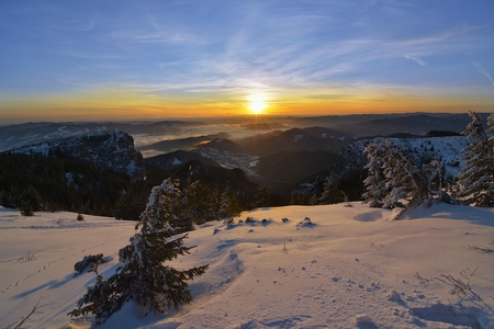 Amazing sunrise in Ceahlau mountains, winter landscape.の写真素材