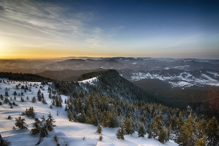 Sunrise above the mountain peaks, view from Ceahlau mountains, Romania.の写真素材