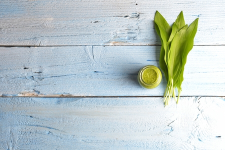 Bear's onion pesto, wild garlic, walnuts and pesto on blue wooden backgroundの写真素材