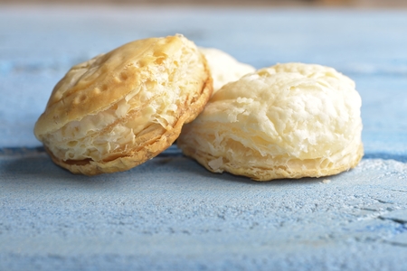 Mini cheese filled baked pies isolated on blue wooden backgroundの写真素材
