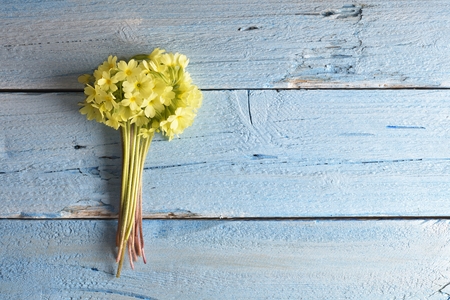 Spring cowslip flowers on a wooden background, Decorative frame or border with primula veris flowers on a wooden backgroundの写真素材