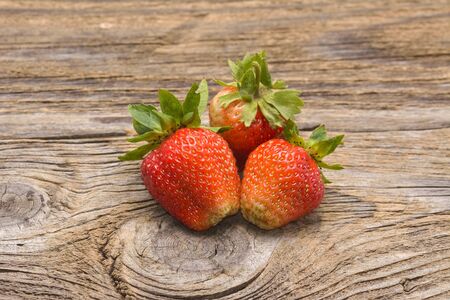 Fresh strawberries on old wooden backgroundの写真素材