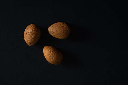 Almonds in nutshell isolated over black backgroundの写真素材
