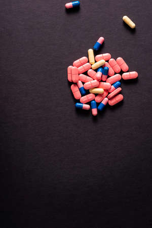 Pharmaceutical medicament, Close-up of pile of blue and pink tablets capsule.の写真素材