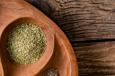 Dried rosemary leaves - Rosmarinus officinalis on wooden backgroundの写真素材